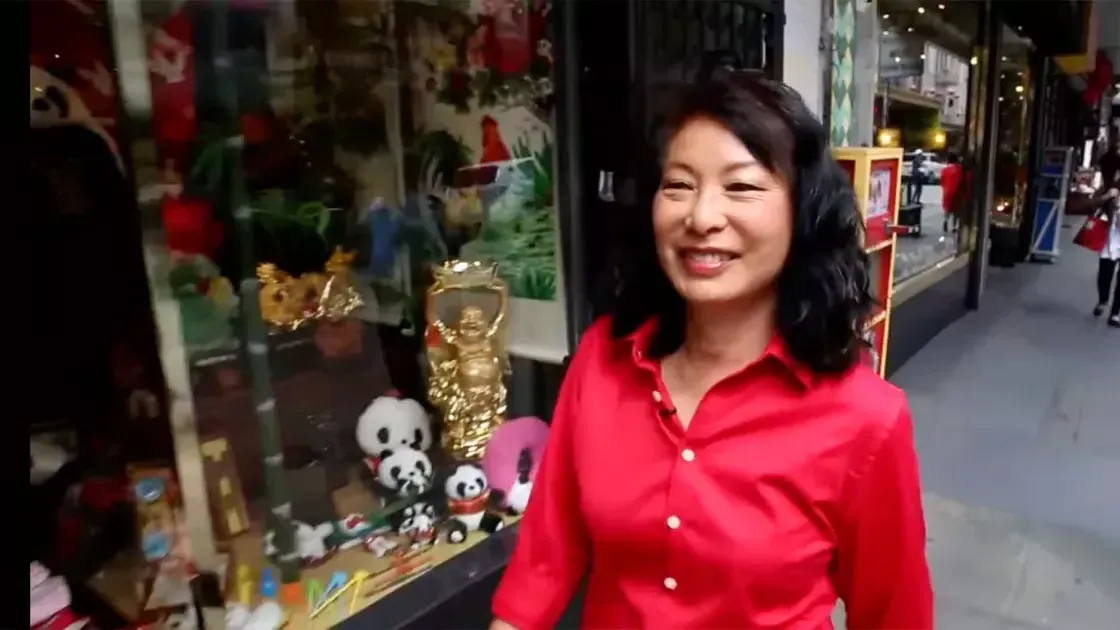 Linda Lee walks through the streets of Chinatown wearing a red shirt. 贝博体彩app，加州.